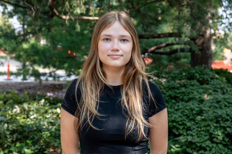 Headshot of Alexandra Romanova. Outdoors, wearing a black blouse.