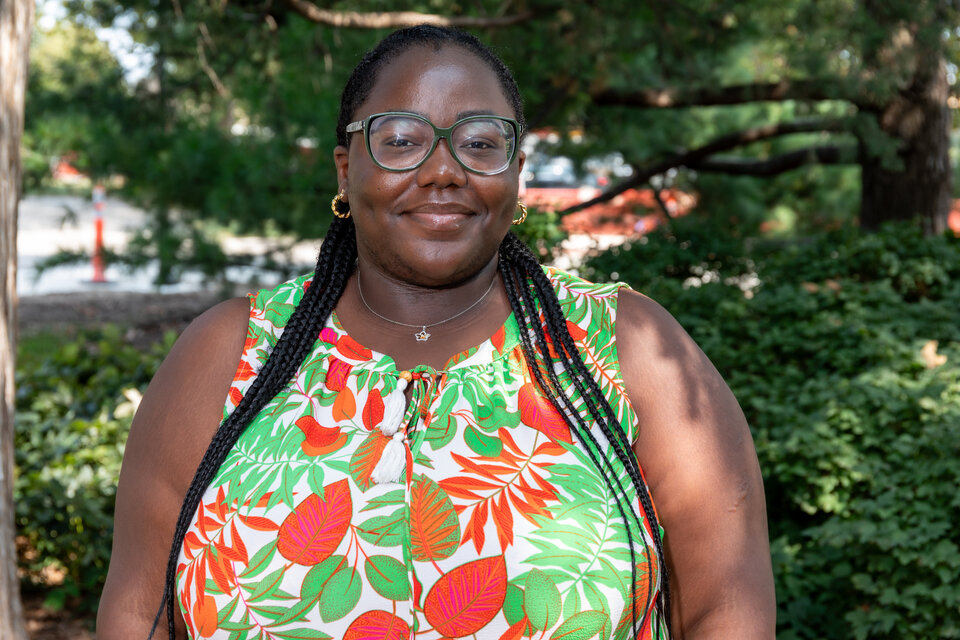 Headshot of Anaelle Kervela Nimpa Kamoto. Outdoors, wearing a floral dress.